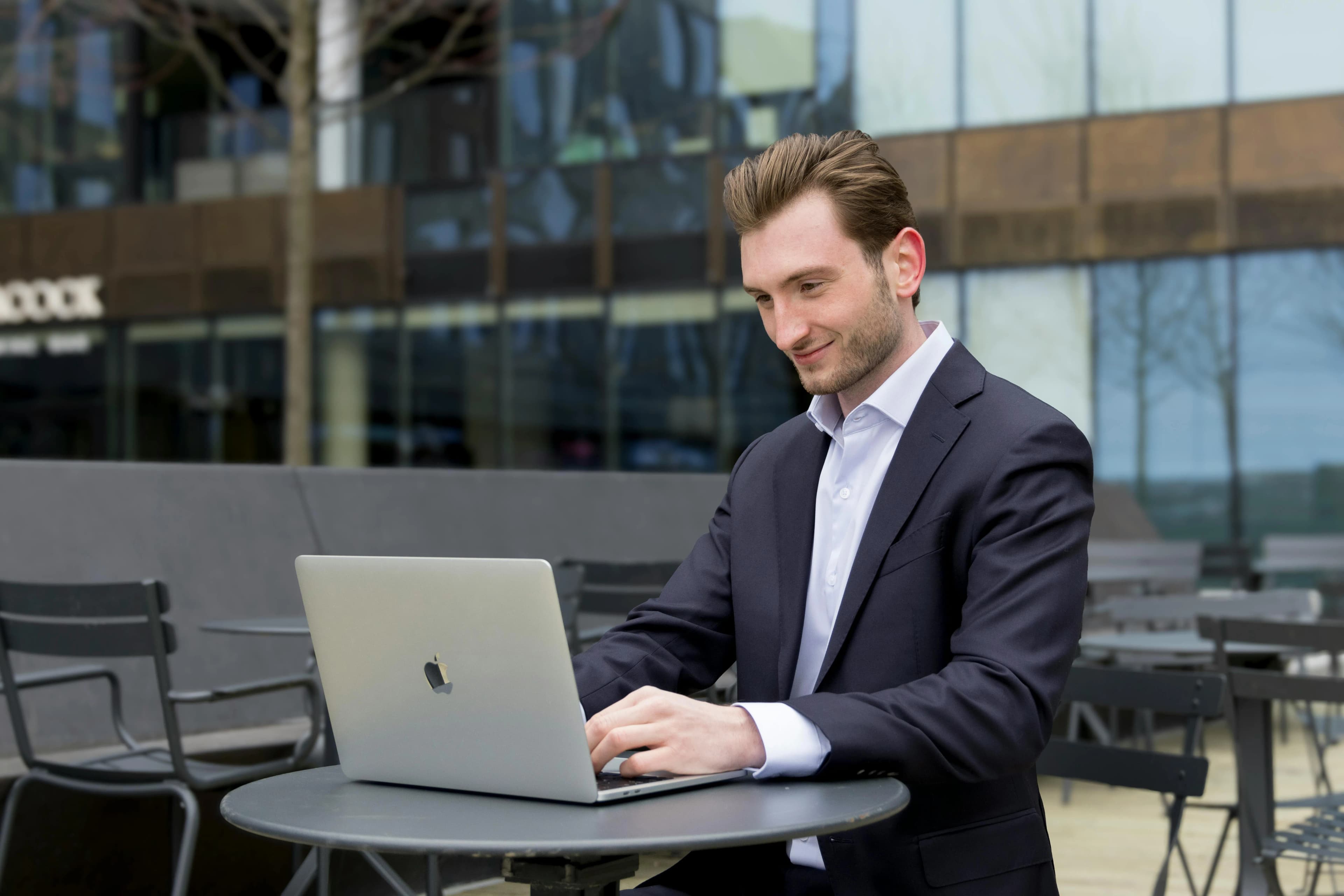Business professional working on a laptop in a modern corporate setting