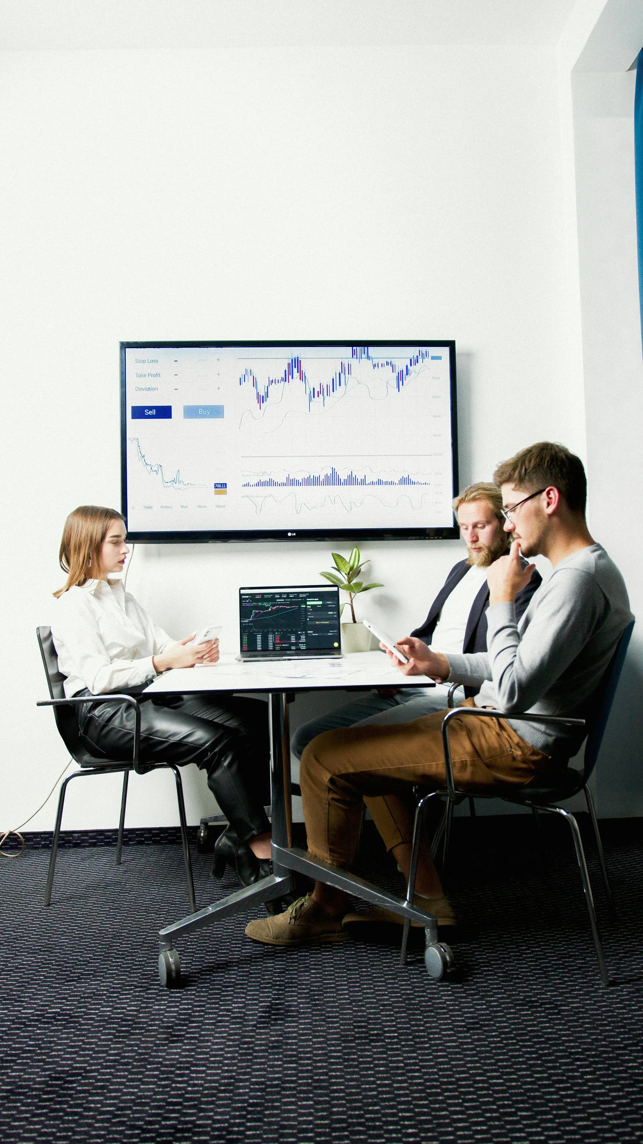 Corporate team in a meeting reviewing business data together